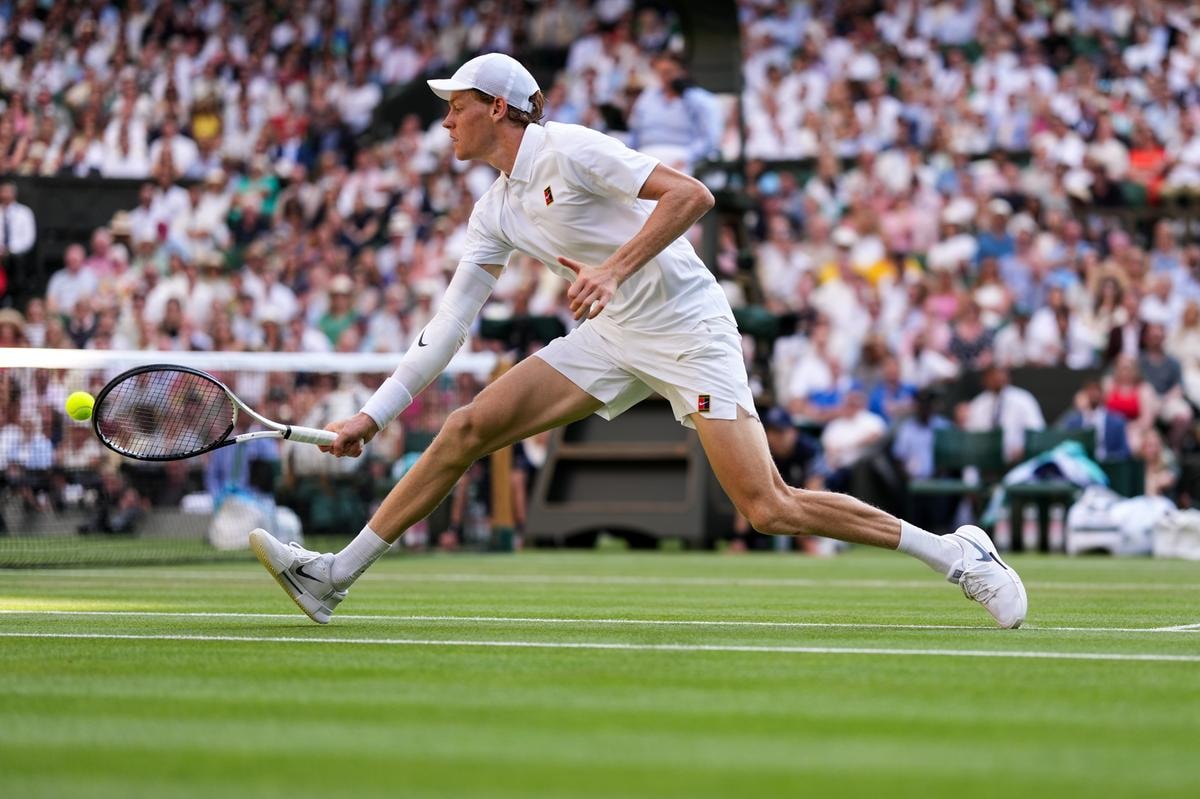 LONDON, ENGLAND - JULY 13: Jannik Sinner of Italy plays a backhand in the Gentlemen's Singles Final match against Carlos Alcaraz of Spain on day fourteen of The Championships Wimbledon 2025 at All England Lawn Tennis and Croquet Club on July 13, 2025 in London, England. (Photo by Shi Tang/Getty Images)