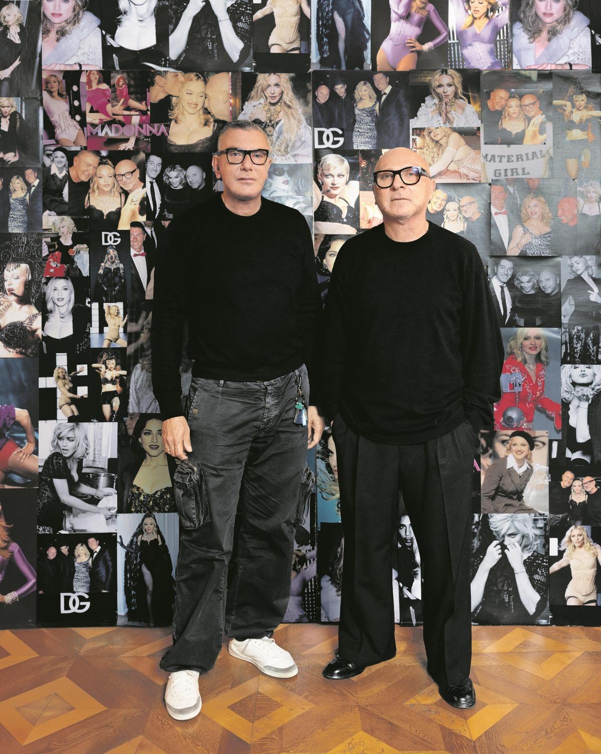 Stefano Gabbana e Domenico Dolce con un wall di immagini che li ritraggono insieme a Madonna (courtesy Dolce&Gabbana)