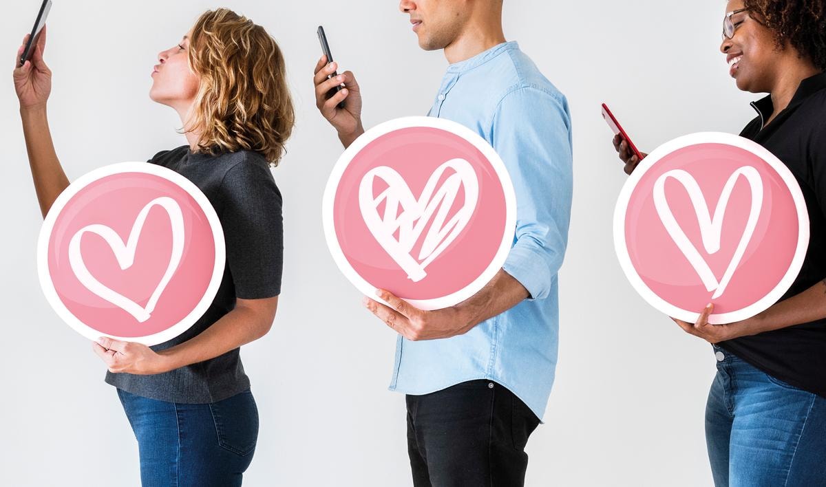 Diverse people holding valentine icons
