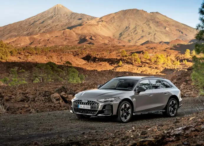 Audi A6 allroad (plateau grey metallic) in a volcanic landscape with a striking mountain panorama.